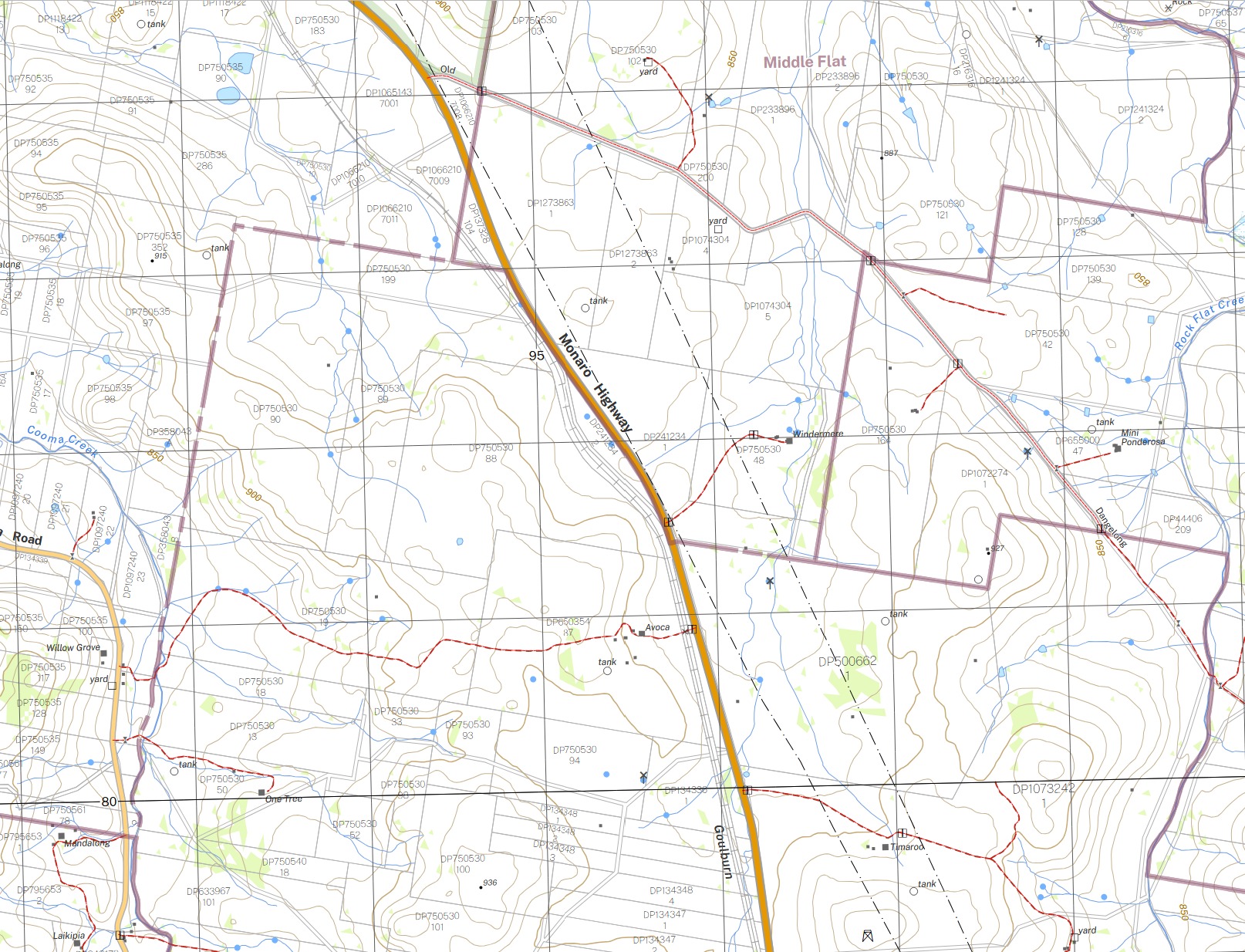 Extract from the Jillimatong 1:25,000 topographic map covering Rock Flat. The Monaro Highway runs north-west to south-east through the sheet with the homestead Avoca labelled beside it. Lot 1 DP500662 is named to the east of the highway. Two transmission lines, drawn as black dash-dot lines, run parallel across the holding from north-north-west to south-south-east. Brown contours at a 10 metre interval are widely spaced across the paddocks, with index contours labelled 850 and 900 metres and spot heights of 887, 915, 927 and 936 metres nearby. Blue non-perennial watercourses and circular tank symbols are scattered across the property.