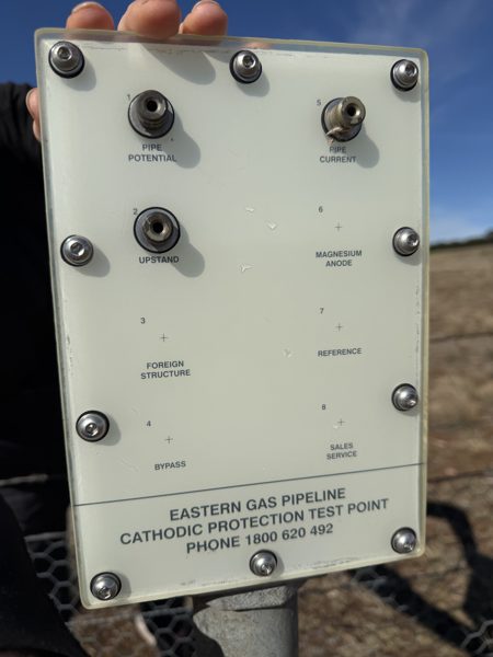 A cream coloured test point panel labelled Eastern Gas Pipeline cathodic protection test point, with terminals for pipe potential and pipe current.